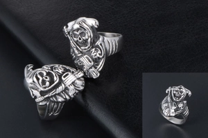 Macro view of detailed Grim Reaper with scythe carving on silver punk skull ring