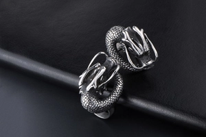 Macro view of vintage silver dragon ring with detailed scales and engraved textures