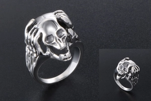 Detailed macro view of vintage stainless steel skull ring with punk skeletal claw elements