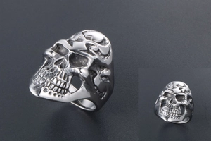 Detailed macro view showing a 3D silver skull ring with gothic punk metal textures