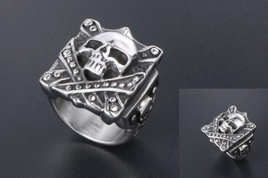 Detail of square skull relief ring with textured bone elements and steel finish