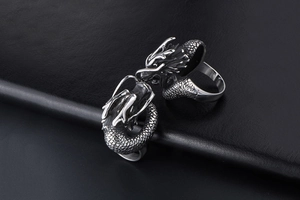 Detailed close-up of vintage dragon ring featuring intricate scales and silver finish