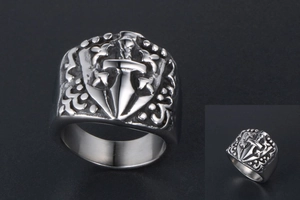 Close-up of gothic stainless steel shield ring featuring a carved cross sword design