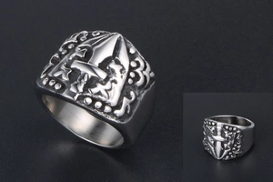 Macro detail of gothic sword and shield relief on vintage oxidized titanium steel ring