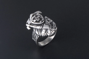 Detailed close-up of punk style grim reaper skull ring made of polished titanium steel