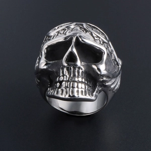 Punk vintage skull ring in stainless steel with intricate floral carvings and aged finish