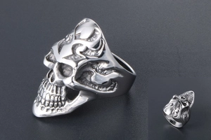 Macro detail of punk skull ring with flame engraving and polished silver finish