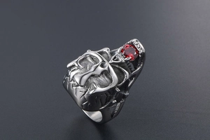 Macro detail of gothic skull ring with red rhinestone and vintage oxidized steel texture