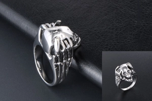 Detail view of silver punk skull ring for men with Gothic skeleton bone structure