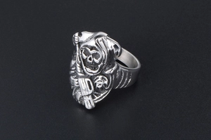 Detail of grim reaper skull ring showing intricate gothic metal engraving and retro finish