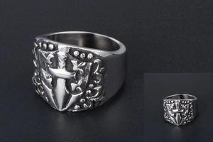 Detailed macro view of vintage gothic shield ring with cross sword engraving and aged finish