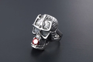 Detailed punk skull ring featuring a red gemstone inlay and intricate silver engravings