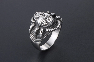 Macro view of gothic spider skull ring in vintage black steel with detailed engraving