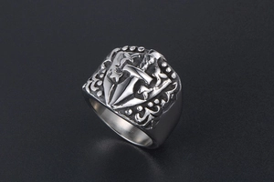 Detailed view of gothic silver ring featuring medieval sword and shield engraving