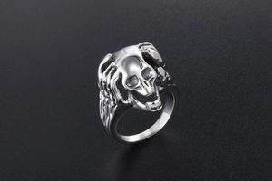 Macro view of vintage stainless steel skull ring with gothic skeleton hand details