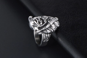 Detailed close-up of a silver skull reaper ring featuring gothic punk metal textures