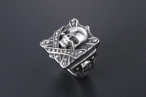 Detailed close-up of retro punk style skull ring with vintage silver finish and rivets