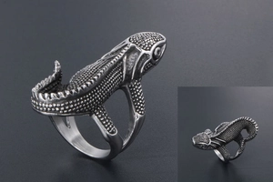Macro view showing detailed scales and blackened vintage finish on a lizard ring