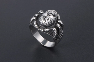 Macro shot of punk skull ring with spider leg carvings and oxidized vintage finish