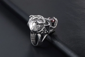 Macro shot of gothic crown skull ring with red ruby stone and vintage steel finish