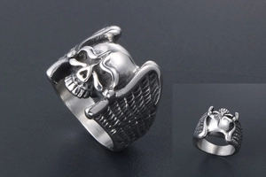 Macro detail of punk skull ring with angel wings in retro vintage polished steel