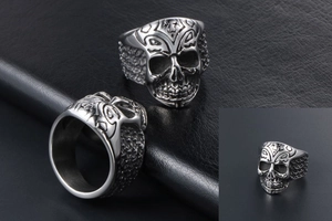 Close-up of vintage skull ring with tribal carvings and distressed stainless steel texture