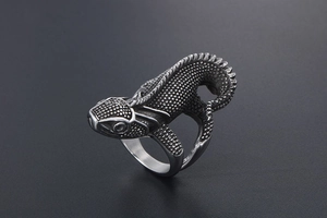 Macro shot of punk lizard ring with detailed scales and vintage stainless steel finish