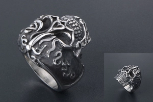 Macro detail of gothic skull ring with vintage cloud pattern and oxidized relief