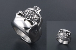 Detailed close-up of a punk-style bearded skull ring with polished silver finish and relief