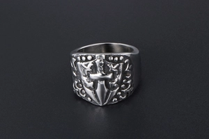 Close-up of vintage gothic shield ring featuring sword engraving and matte silver finish