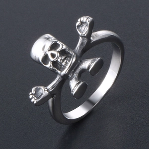 Unique punk skull ring in silver stainless steel with crossed arms design shown at 45 degrees