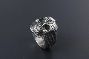 Detail shot of vintage skull ring in titanium steel with dark honeycomb texture