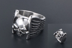Detailed view of punk style skull ring with angel wings in polished stainless steel