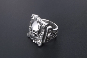 Detailed close-up of a punk style stainless steel skull ring with vintage silver finish