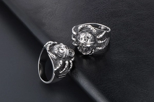 Detail of vintage punk skull rings in titanium steel with aged finish and bone structure