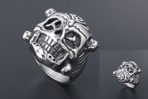 Detailed close-up of a vintage skull ring with intricate gothic carvings and silver finish
