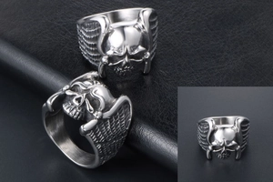 Macro detail of gothic angel wing skull ring showing vintage punk steel textures