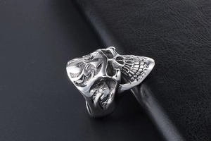 Macro view of punk skull ring with side flame hollow patterns on black leather