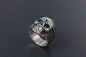 Detail of vintage skull ring in punk style with aged silver finish and steel texture