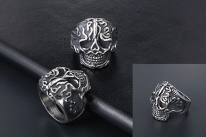 Close-up of gothic skull ring with vintage silver patterns and etched flame details
