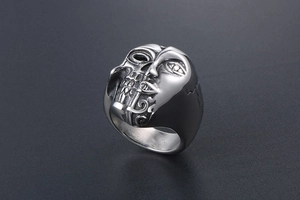 Gros plan sur bague gothique Janus avec visage divisé et crâne en acier inoxydable