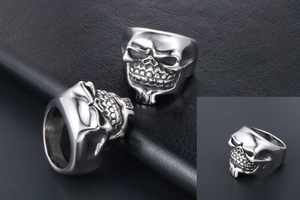 Macro detail of silver punk skull ring with beard and vintage texture on black leather