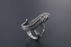 Detailed macro view of retro punk lizard ring with realistic scale texture and metallic finish