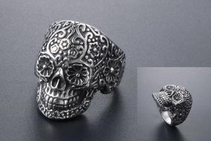 Macro shot of silver vampire skull ring with intricate floral gothic carvings
