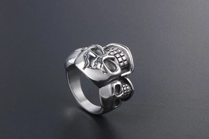 Detailed view of punk style double skull ring in vintage silver finish stainless steel
