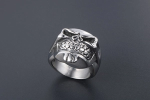 Macro view of vintage silver skull ring showing detailed beard and punk metal texture