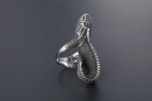 Macro shot of silver titanium lizard ring featuring realistic reptile scale textures