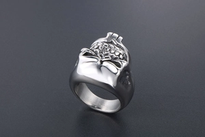 Detailed view of punk style silver skull ring with mechanical mask and steel texture