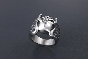 Detailed macro view of silver steel ring with heart armor design and textured band