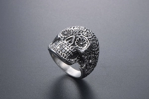 Detailed view of punk skull ring with floral engraving in vintage stainless steel